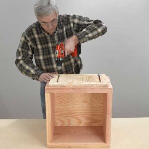 8. Screw the base and the plywood bottom together. Set the adjustable leg against one…